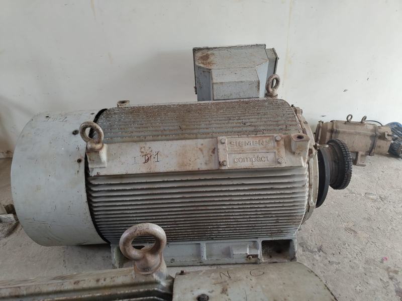 Side view of a large Siemens induction motor with lifting eyes, at the Chani Electricals workshop