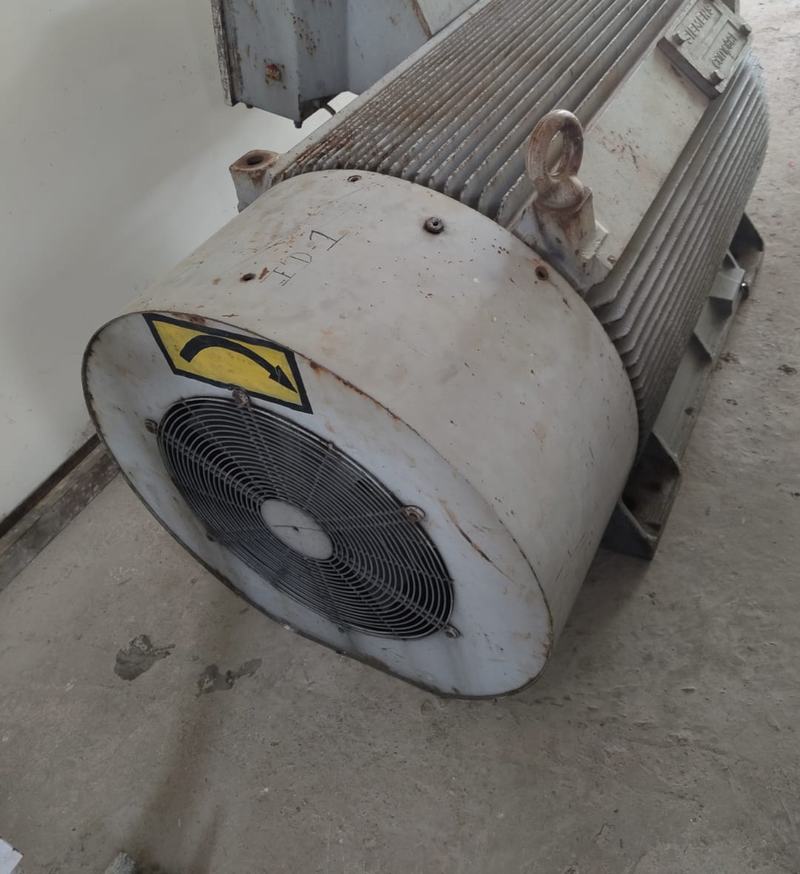 The fan end of a large induction motor standing in the workshop