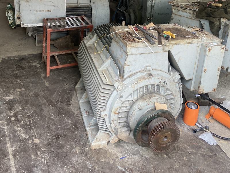 Large three-phase induction motors on the floor of the Chani Electricals workshop in Loni